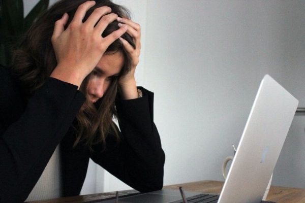 woman stressed sat at laptop
