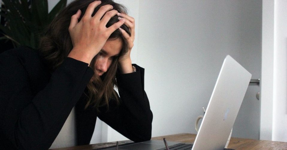 woman stressed sat at laptop