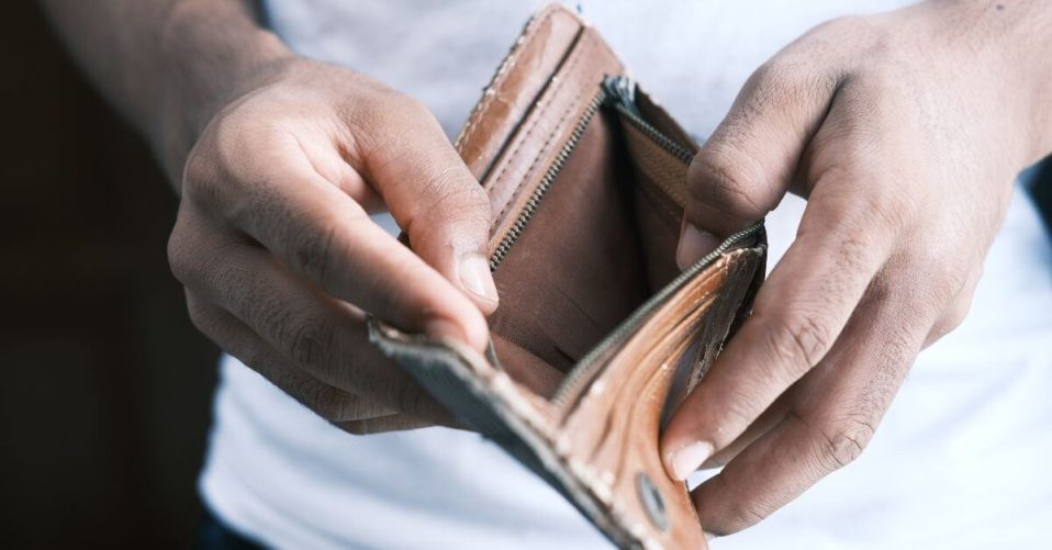 person holding open a empty wallet