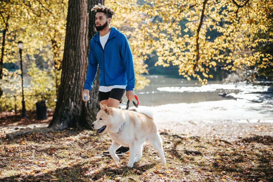 man walking his dog in the forest practicing mindfulness